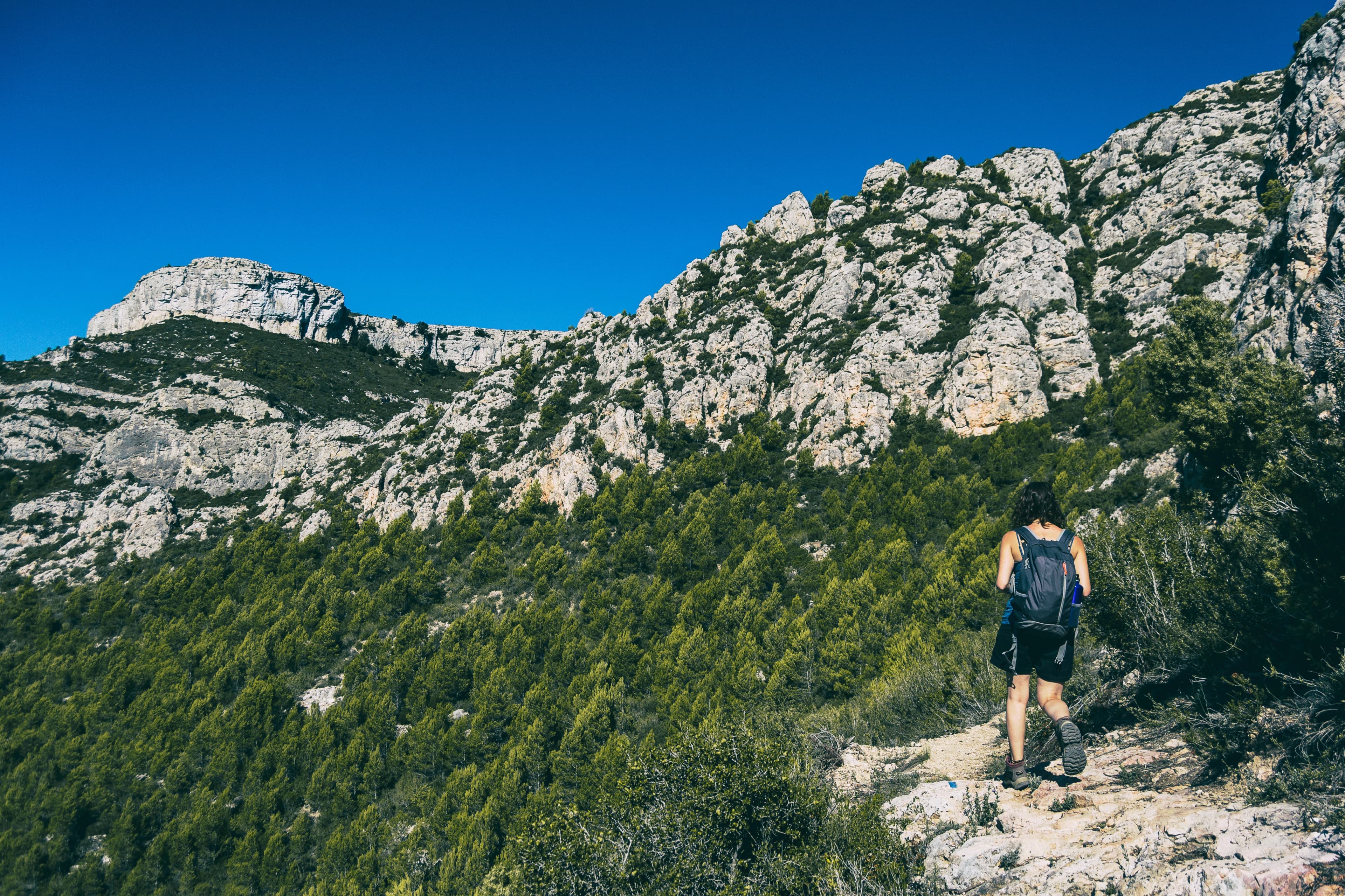 woman hiking on a mountain path in catalonia