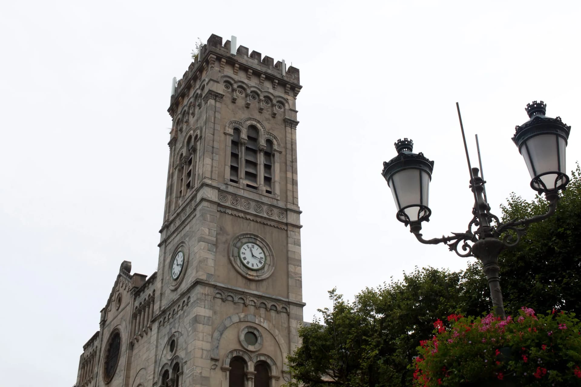 Church in Saint Lary in front of a lamppost, France