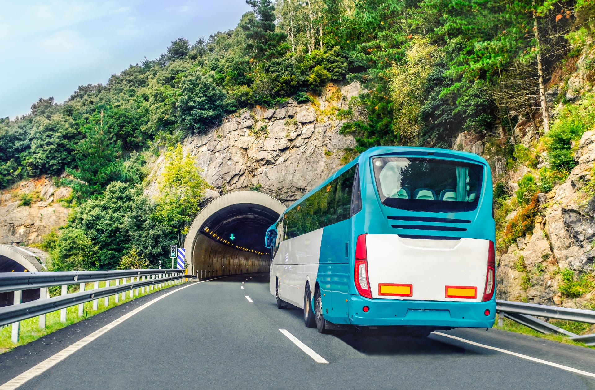 Coach, long haul bus, drives through a tunnel in northern Spain